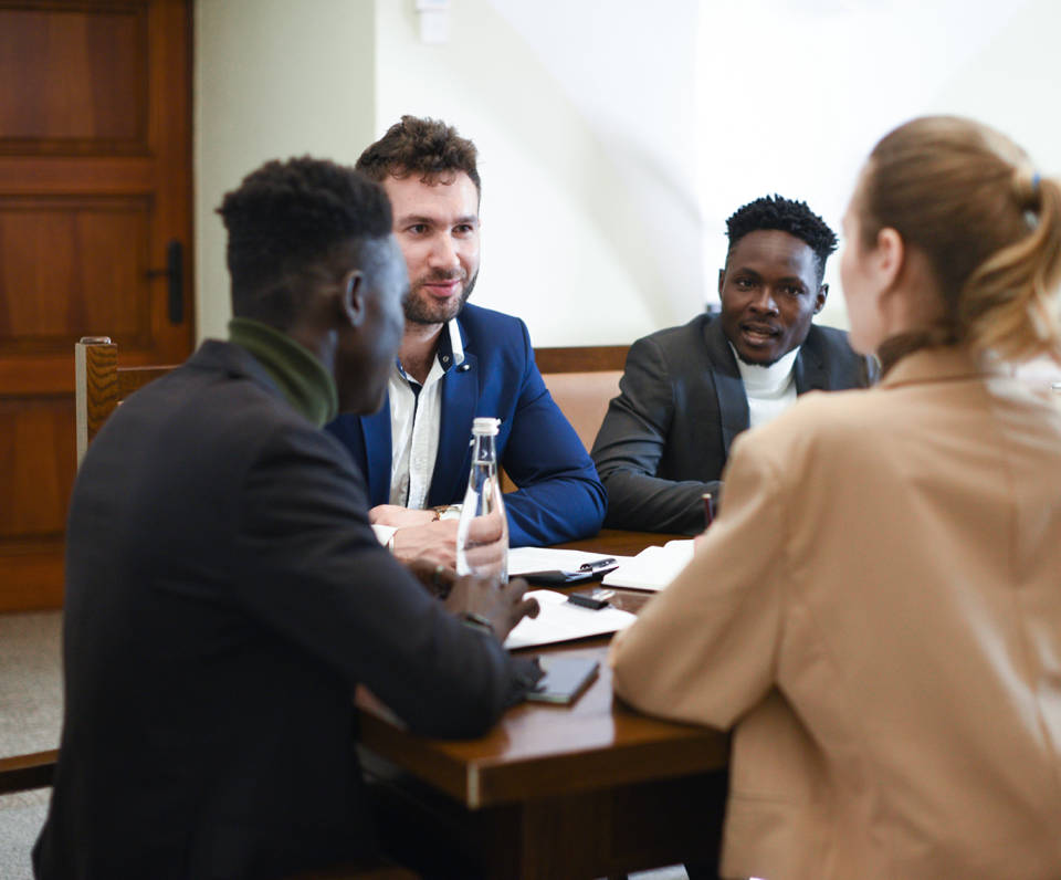 A diverse group of professionals having a business meeting around a table.