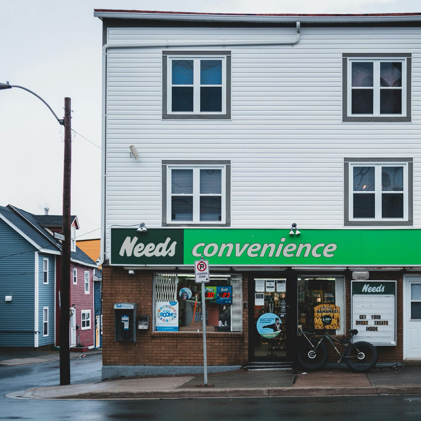 Front view of a convenience store located in a residential urban neighborhood.